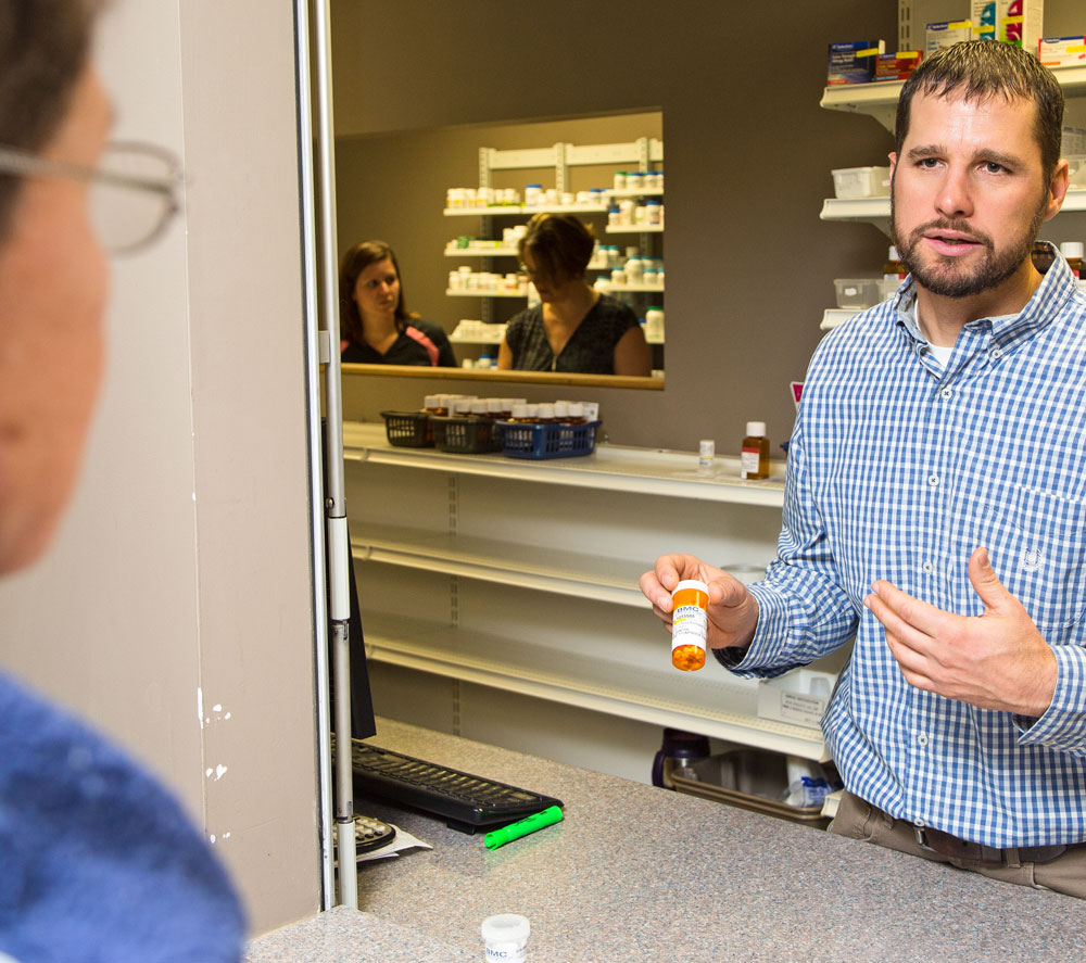 Pharmacist assessing patient prescriptions